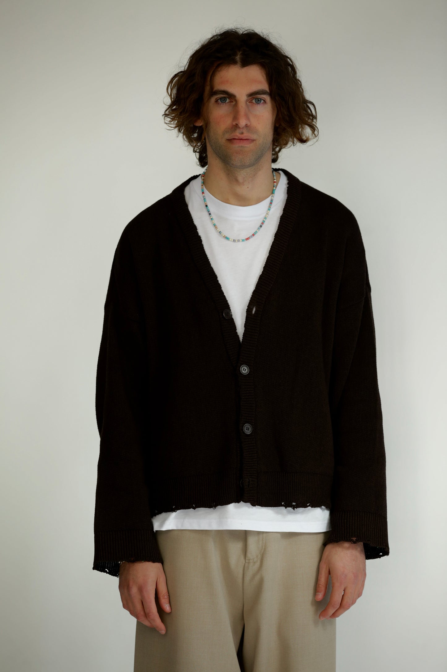 Cardigan nero taglio vivo